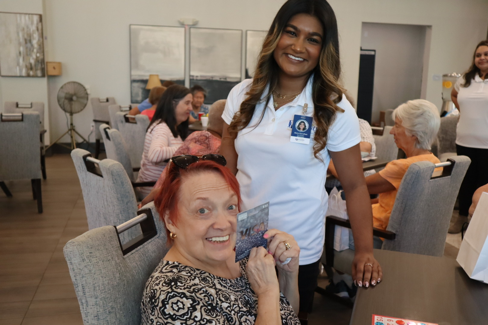 A Dynasty Senior Care team member smiling with a community guest