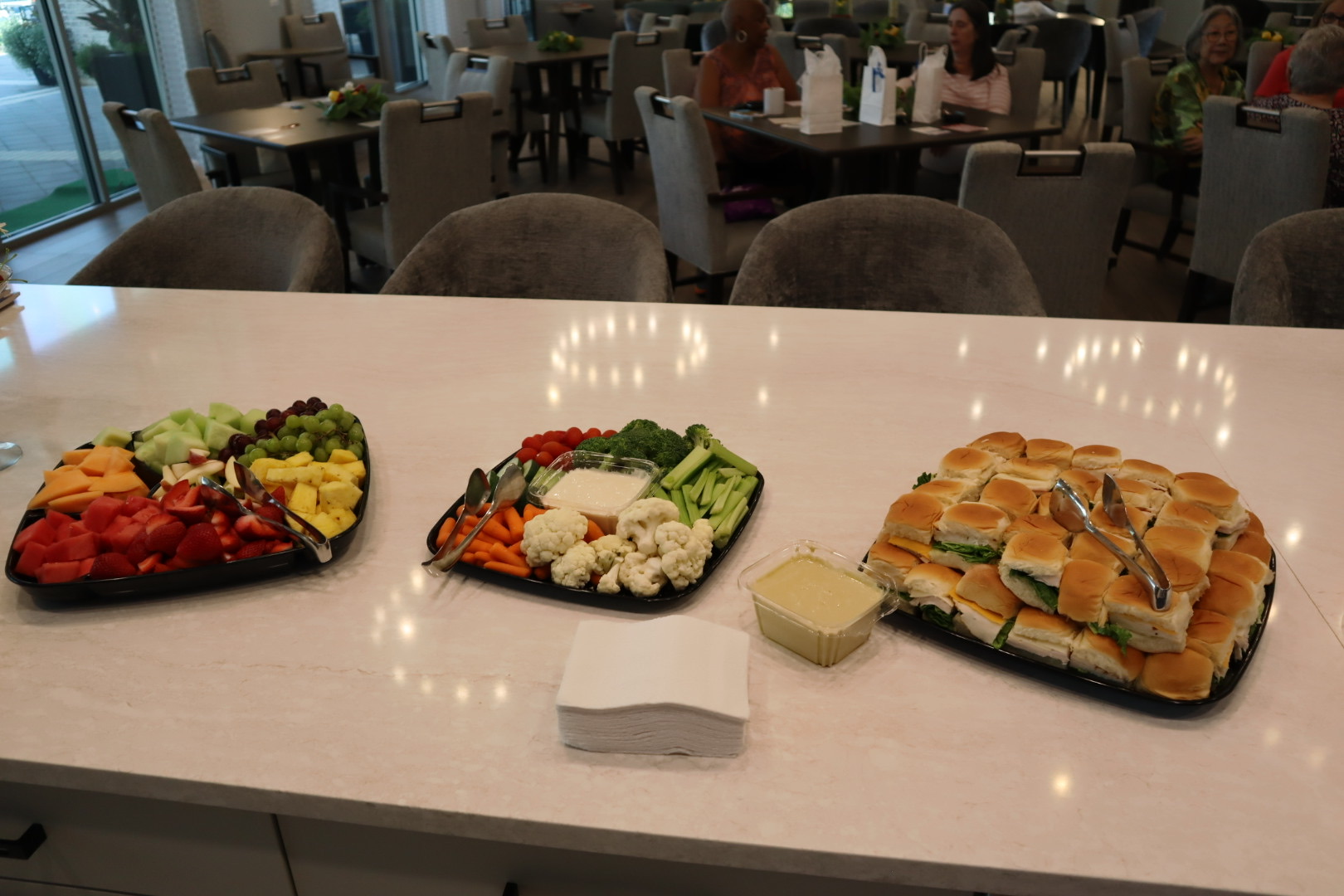 Fruit, vegetables, and sandwiches prepared for the community gathering